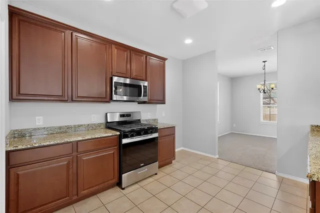 a kitchen with a sink a stove and cabinets