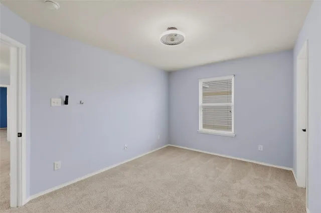 a view of an empty room and a window