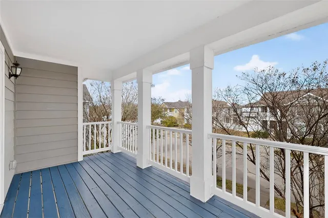 a front view of house with yard and trees in the background