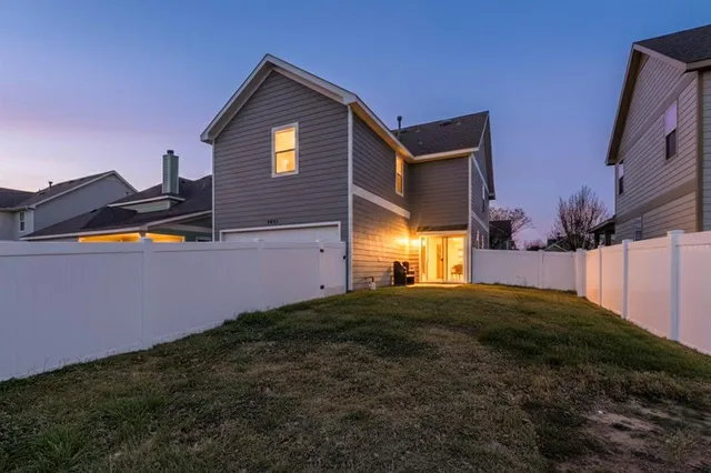 an aerial view of a residential houses with outdoor space