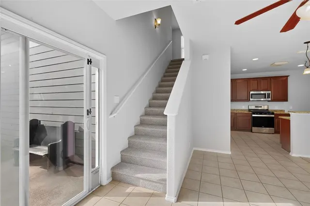 a view of a livingroom with a ceiling fan and window