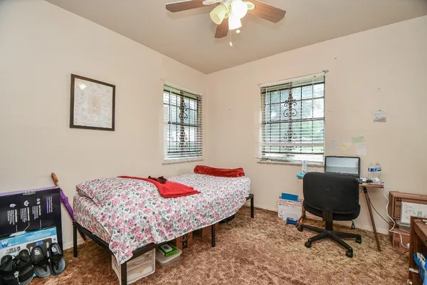 a bed room with a bed and a window