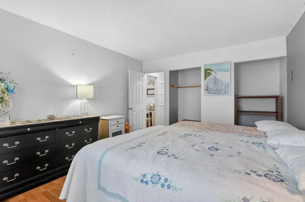 a bedroom with a bed and a dresser