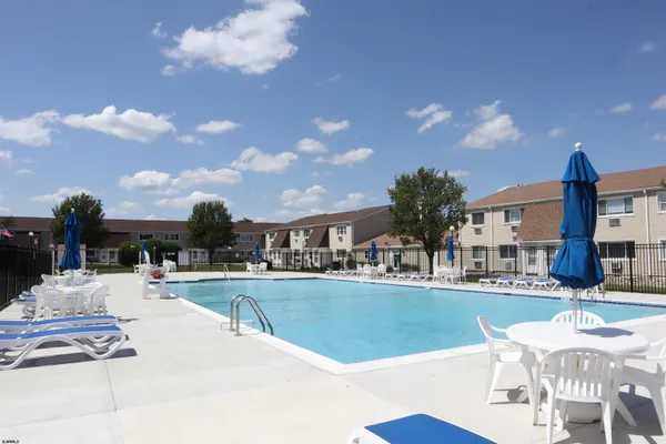 a swimming pool with outdoor seating and yard