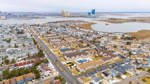 an aerial view of residential building and ocean view