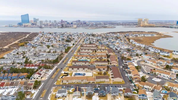 an aerial view of residential building and ocean