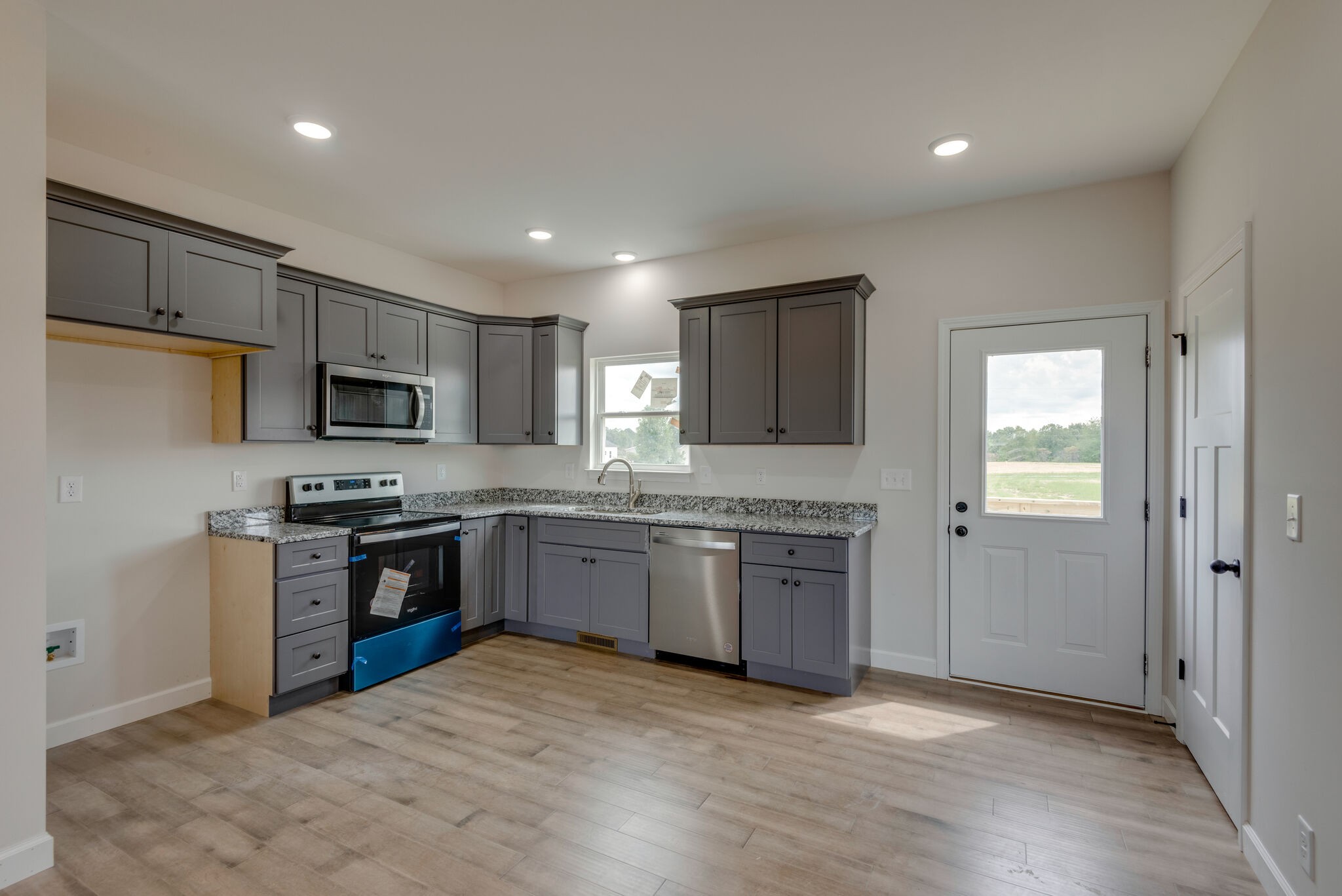 1224 Oak Grove Road Dickson, TN 37055 - Photo 12 of 28 a kitchen with granite countertop stainless steel appliances and wooden cabinets