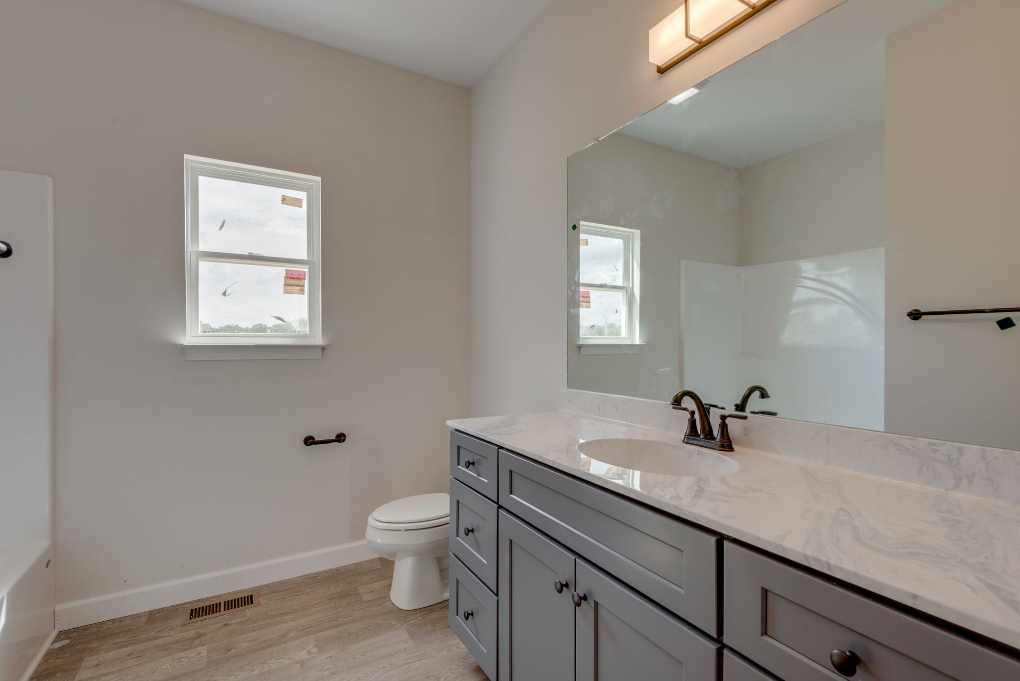 1224 Oak Grove Road Dickson, TN 37055 - Photo 17 of 28 a bathroom with a sink a toilet and a mirror