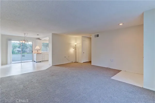 an empty room with large window and mountain view