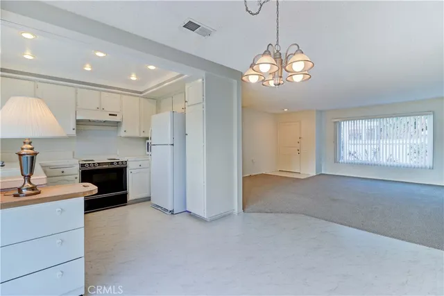 a kitchen with a sink stove and refrigerator