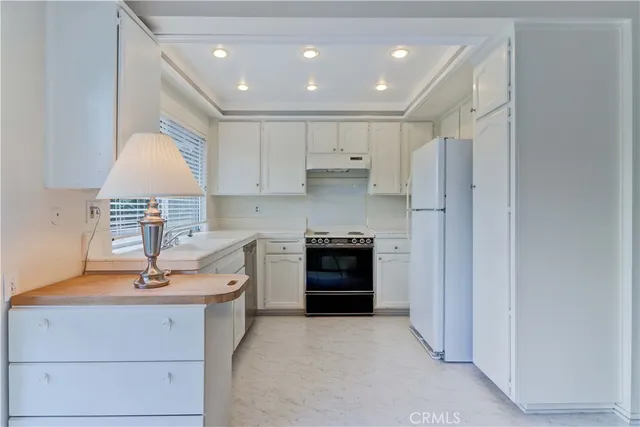a kitchen with appliances cabinets and a window
