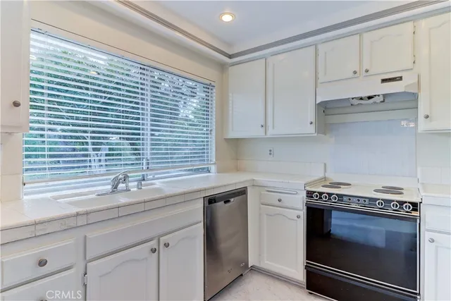 a kitchen with a stove sink and refrigerator