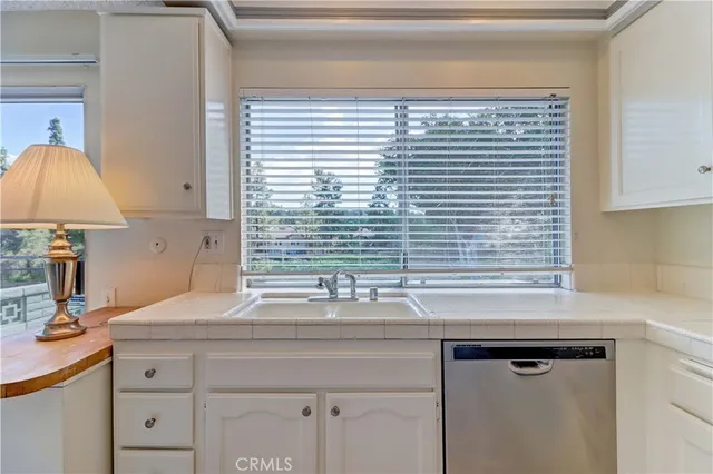 a kitchen with stainless steel appliances granite countertop a refrigerator and a stove