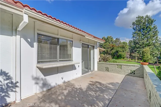 a view of a house with a big yard and large tree