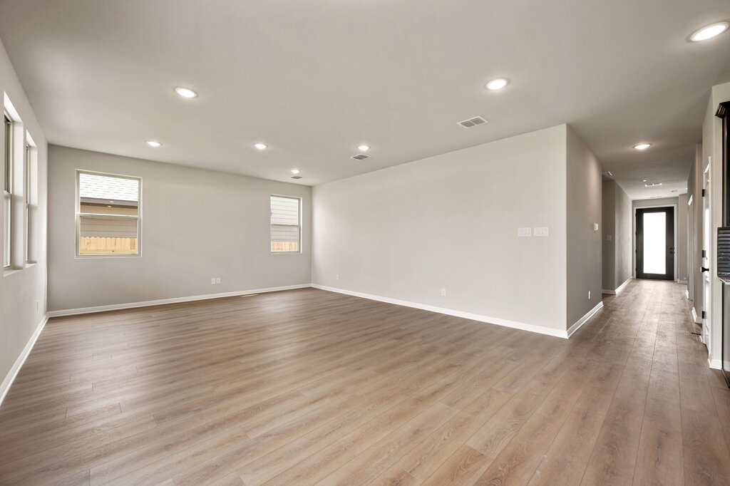 701 Henry Milton Road Georgetown, TX 78626 - Photo 13 of 40 a view of an empty room with wooden floor and a window