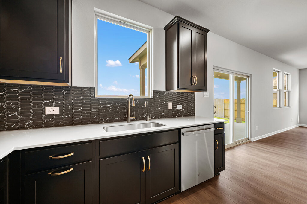 701 Henry Milton Road Georgetown, TX 78626 - Photo 19 of 40 a kitchen with a sink and cabinets