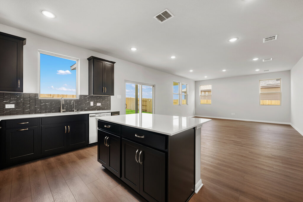 701 Henry Milton Road Georgetown, TX 78626 - Photo 20 of 40 a kitchen with stainless steel appliances granite countertop a sink counter space and wooden floor