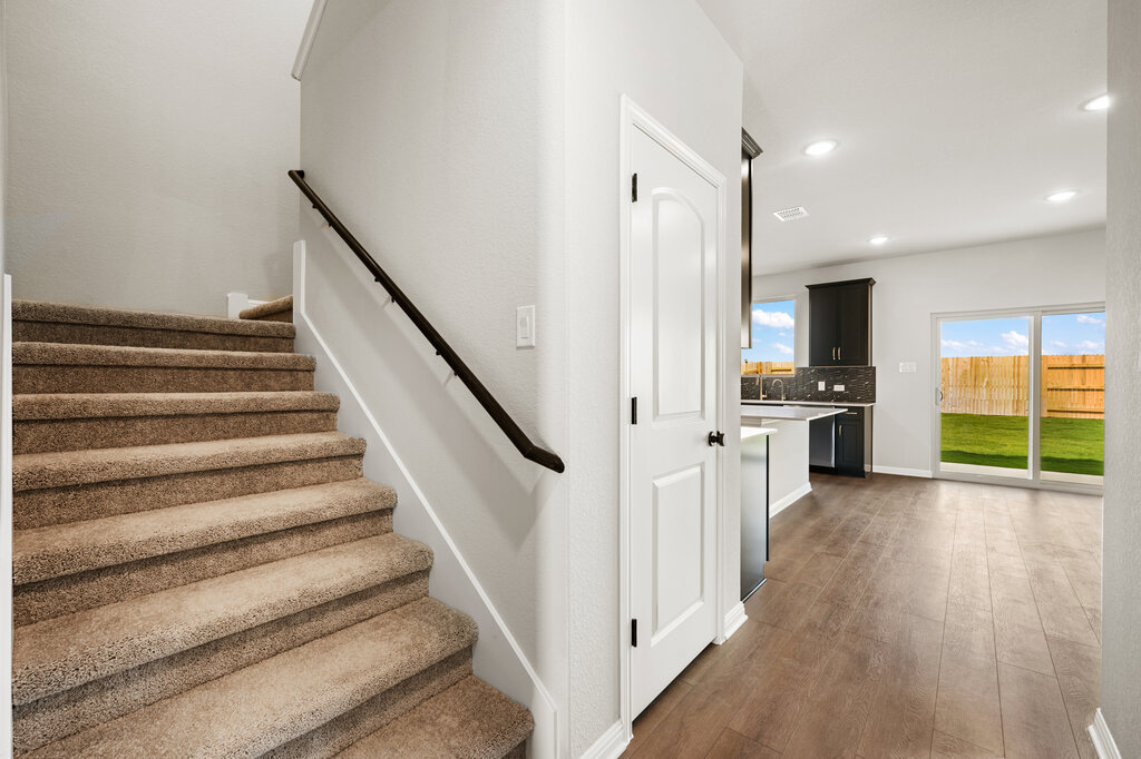 701 Henry Milton Road Georgetown, TX 78626 - Photo 21 of 40 a view of a hallway with wooden floor and staircase