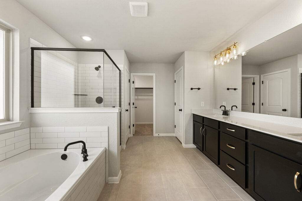 701 Henry Milton Road Georgetown, TX 78626 - Photo 28 of 40 a spacious bathroom with a tub sink shower and mirror