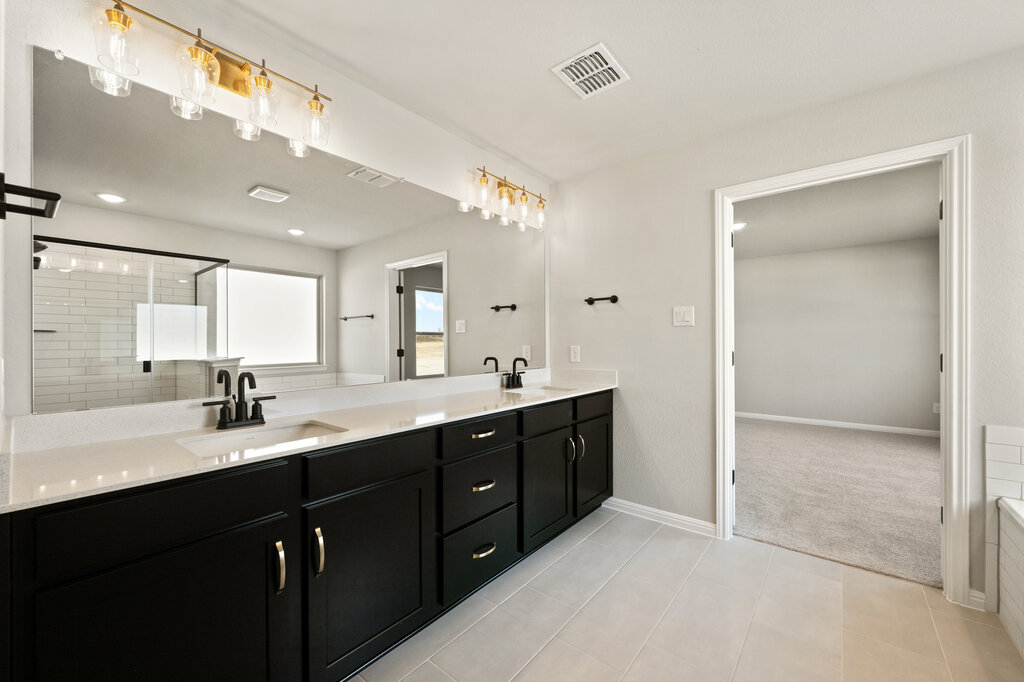 701 Henry Milton Road Georgetown, TX 78626 - Photo 30 of 40 a bathroom with a double vanity sink and mirror