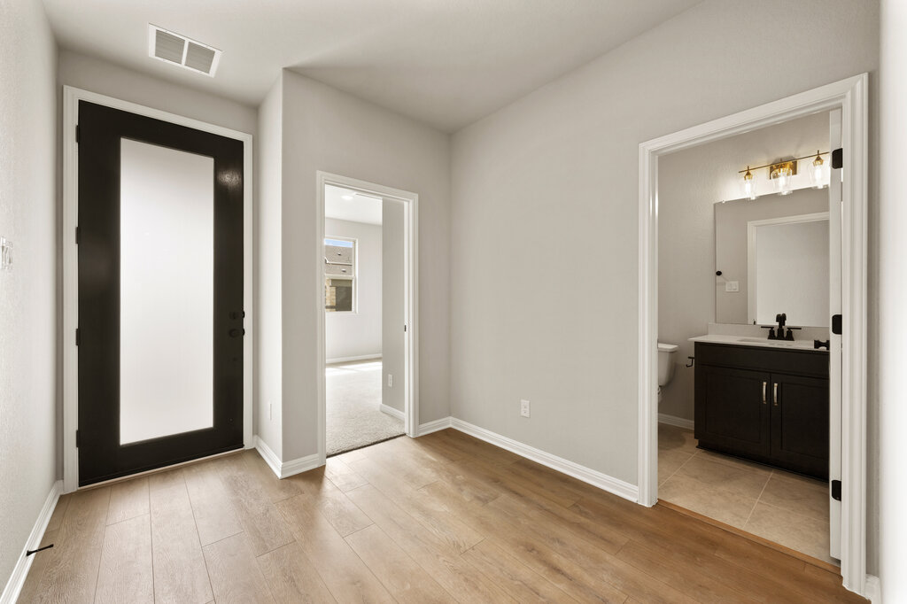 701 Henry Milton Road Georgetown, TX 78626 - Photo 6 of 40 an empty room with mirror and a sink