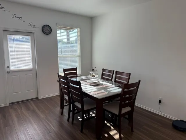 a view of a dining room with furniture and wooden floor