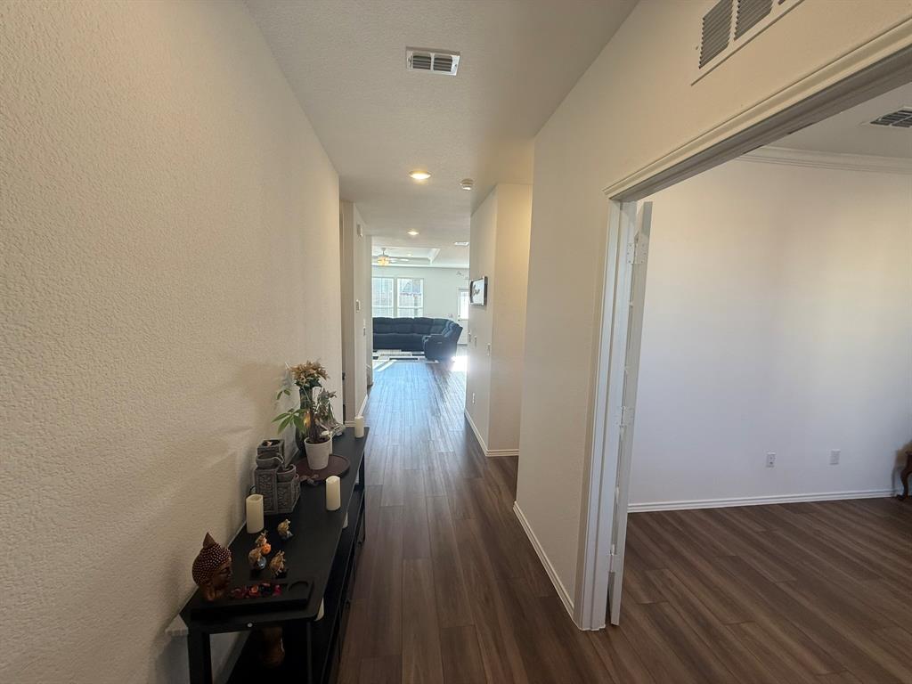713 Agarita Way Princeton, TX 75407 - Photo 12 of 30 a view of a hallway with wooden floor and staircase