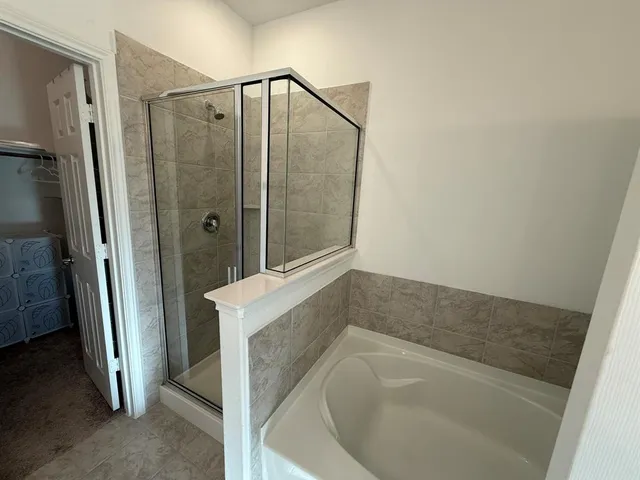 a bathroom with a bathtub and a shower