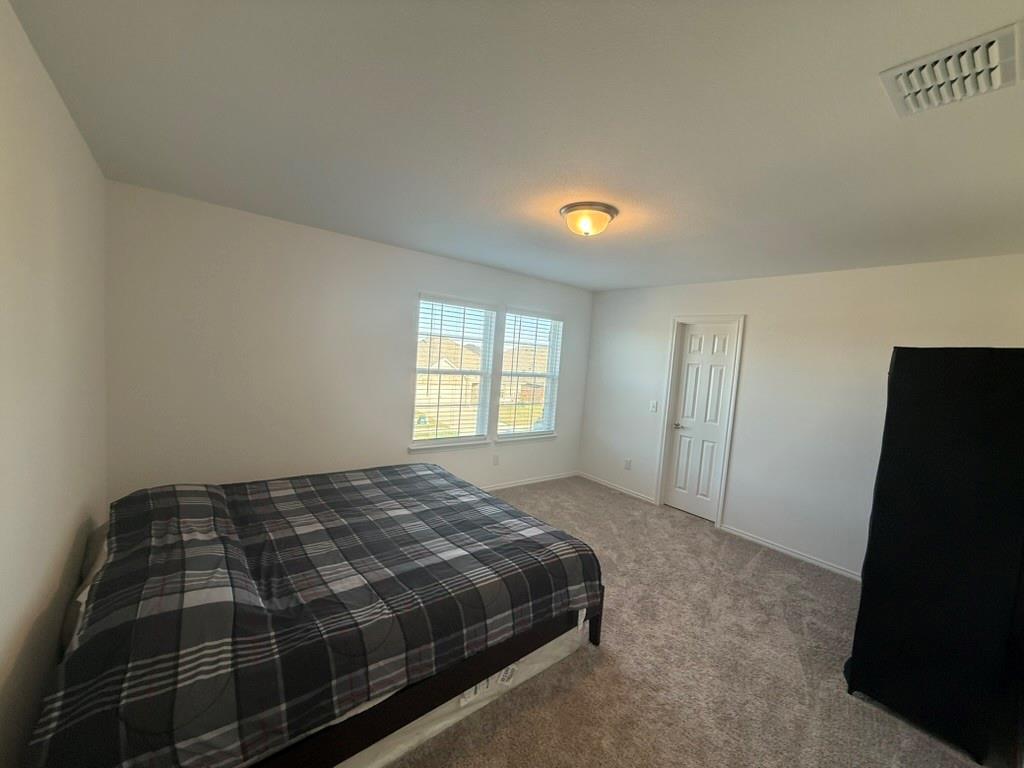 713 Agarita Way Princeton, TX 75407 - Photo 25 of 30 a bedroom with a bed and a window