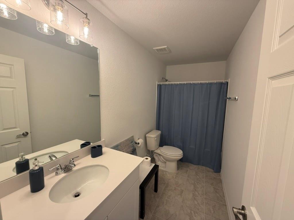 713 Agarita Way Princeton, TX 75407 - Photo 28 of 30 a bathroom with a sink mirror and toilet