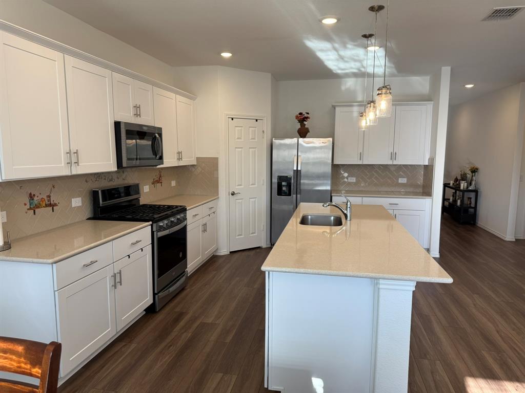 713 Agarita Way Princeton, TX 75407 - Photo 5 of 30 a kitchen with a sink a stove and cabinets