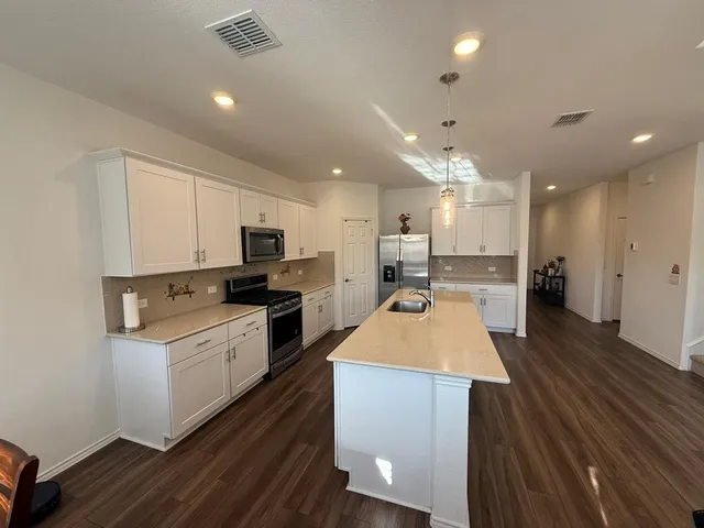 a kitchen with a sink stove and refrigerator