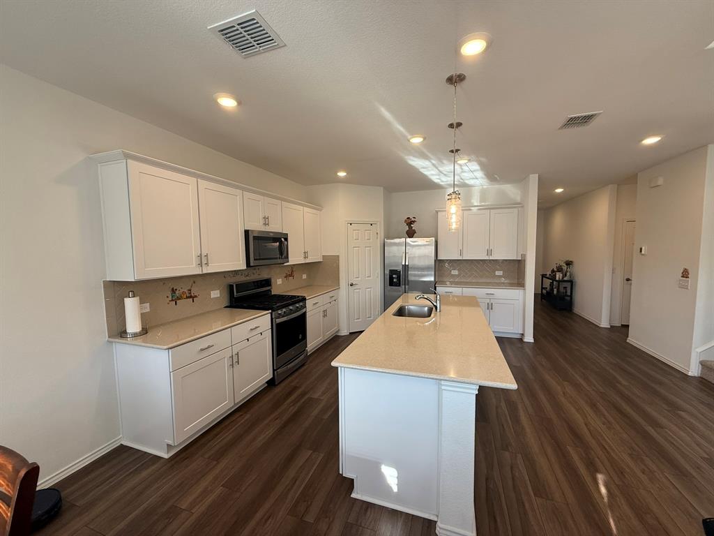 713 Agarita Way Princeton, TX 75407 - Photo 6 of 30 a kitchen with a sink stove and refrigerator