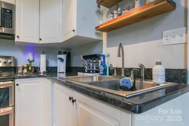 a kitchen with stainless steel appliances granite countertop a stove and cabinets