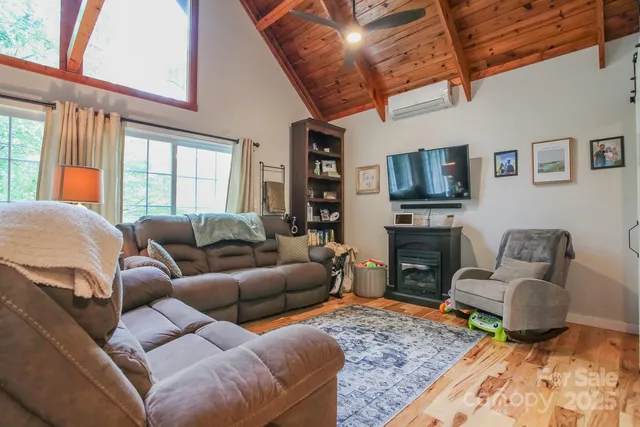 a living room with furniture a rug and a large window