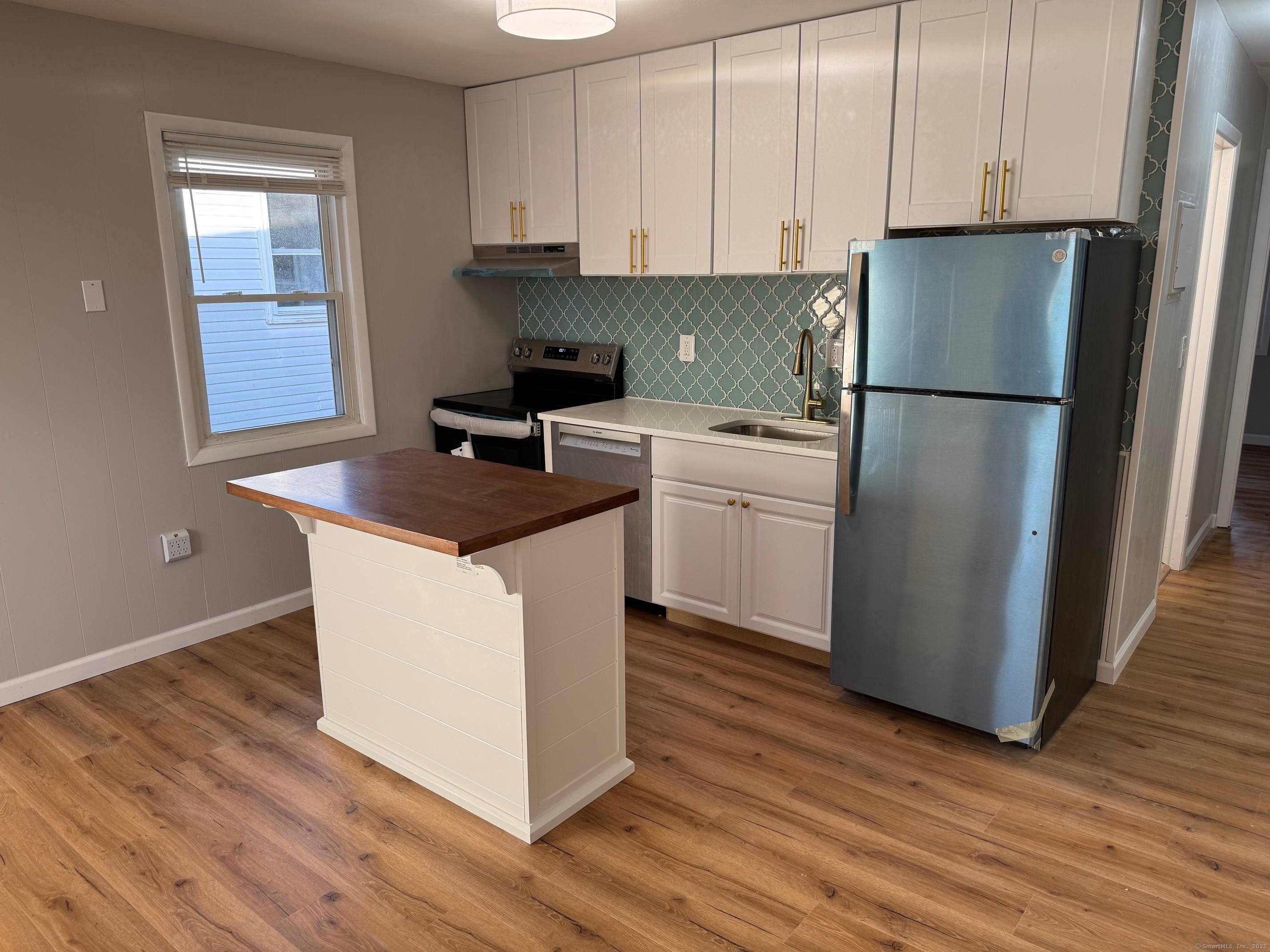 310 Mitchell Street, Unit D4 Groton, CT 06340 - Photo 1 of 1 a kitchen with stainless steel appliances granite countertop a refrigerator sink and cabinets