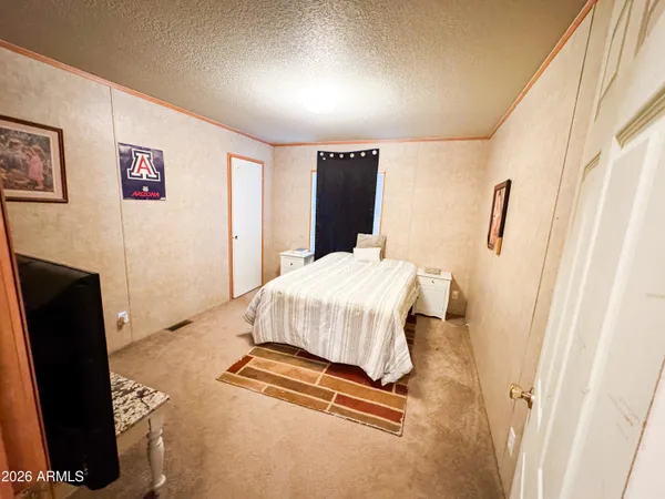 a bedroom with a bed and dresser