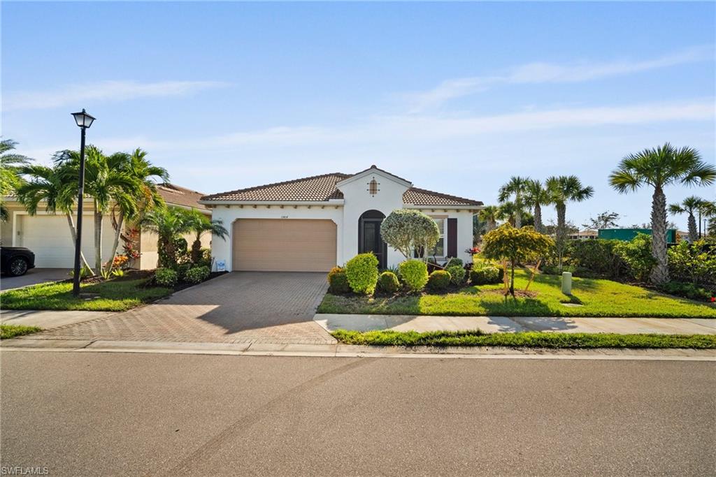 Mediterranean / spanish home featuring a front yard and a garage