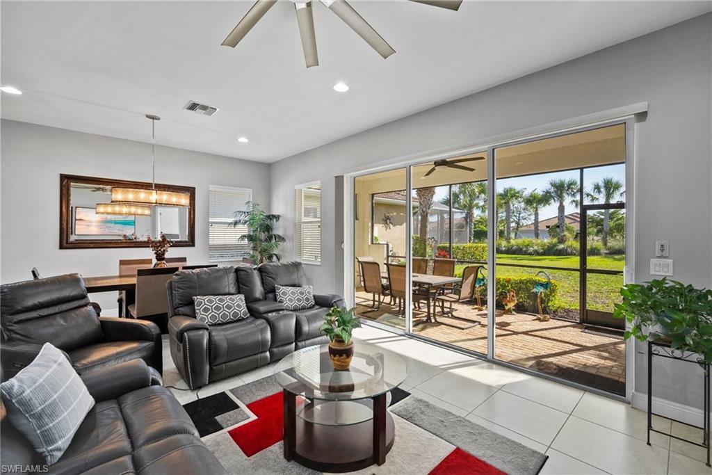 11404 Arezzo Way Fort Myers, FL 33913 - Photo 14 of 36 Tiled living room featuring ceiling fan with notable chandelier