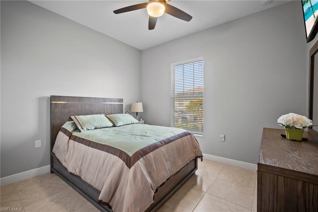11404 Arezzo Way Fort Myers, FL 33913 - Photo 21 of 36 Bedroom with ceiling fan and light tile patterned floors