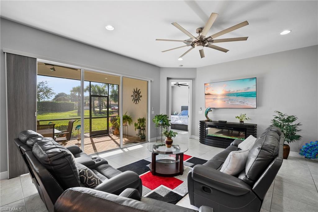 11404 Arezzo Way Fort Myers, FL 33913 - Photo 9 of 36 Living room with light tile patterned floors and ceiling fan