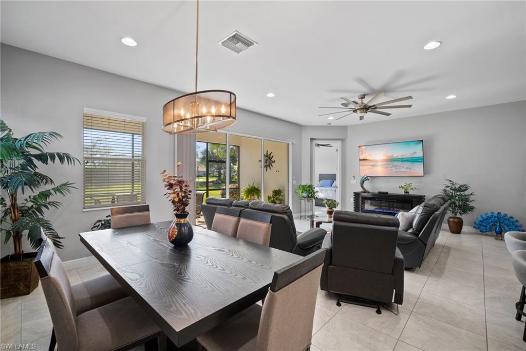 11404 Arezzo Way Fort Myers, FL 33913 - Photo 10 of 36 Tiled dining space featuring ceiling fan with notable chandelier