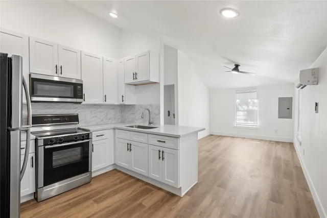 a kitchen with a stove a sink and a refrigerator