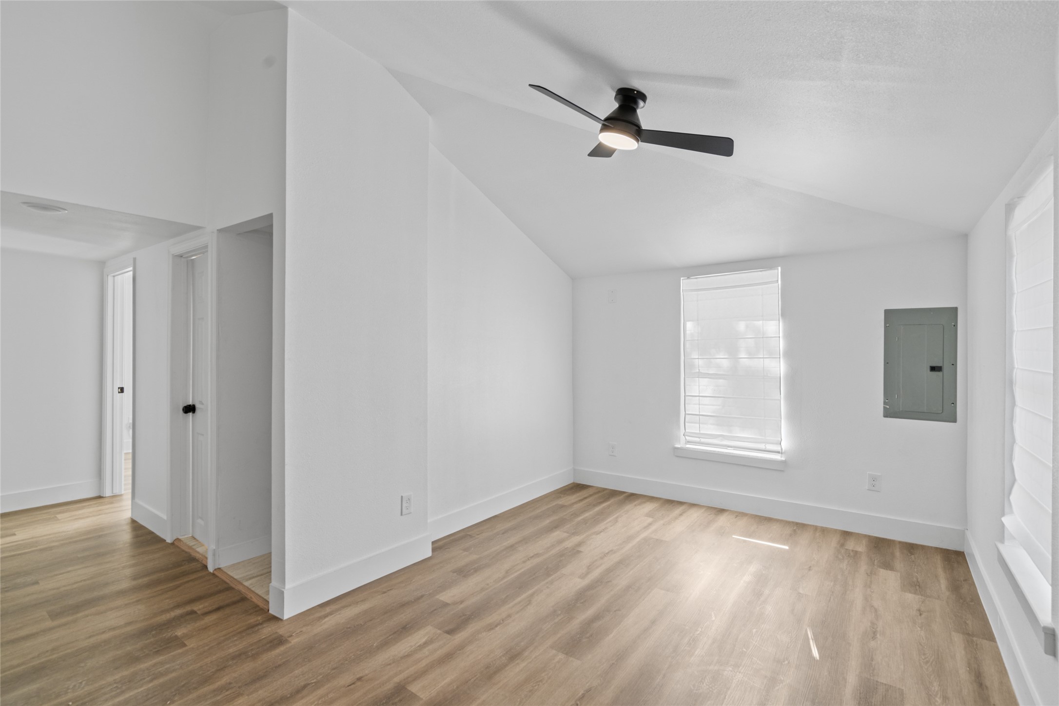 911 Knight Street, Unit D Houston, TX 77022 - Photo 4 of 11 a view of empty room with wooden floor and fan