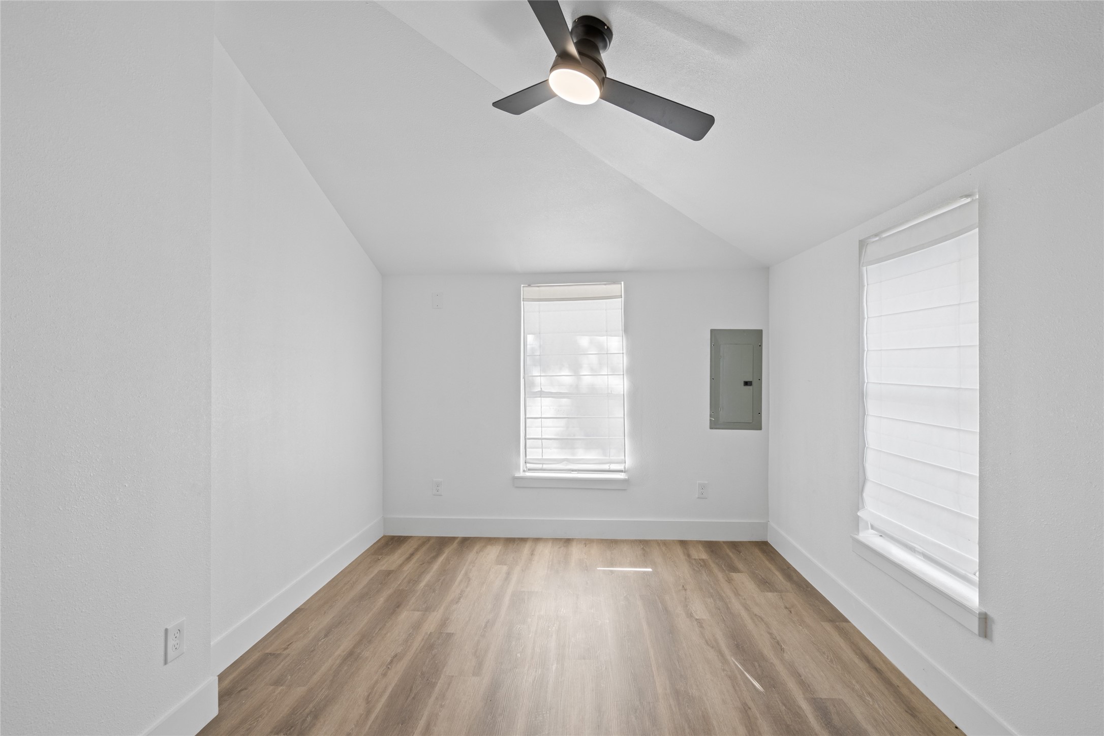 911 Knight Street, Unit D Houston, TX 77022 - Photo 5 of 11 an empty room with wooden floor ceiling fan and windows