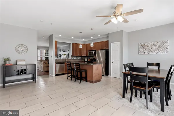 a view of kitchen with refrigerator and chairs