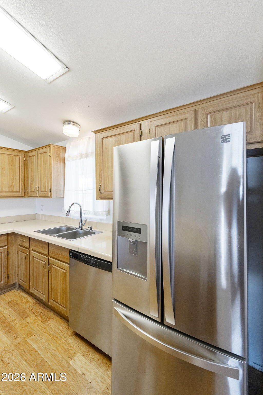 3700 South Tomahawk Road, Unit 73 Apache Junction, AZ 85119 - Photo 11 of 49 a modern kitchen with stainless steel appliances granite countertop a refrigerator and a sink
