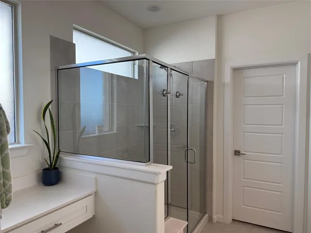 a bathroom with a shower and a sink