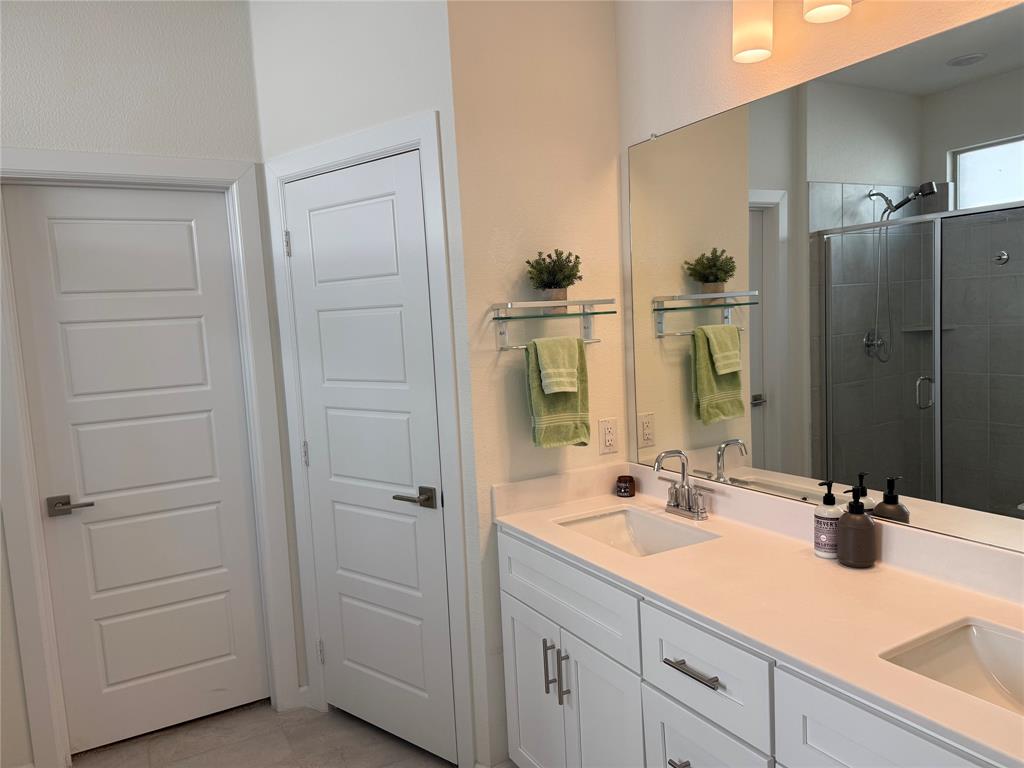 1122 Silverthorne Trail Justin, TX 76247 - Photo 12 of 19 Full bathroom featuring double vanity, a shower stall, and light tile patterned flooring