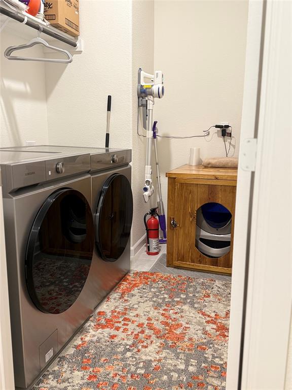 1122 Silverthorne Trail Justin, TX 76247 - Photo 13 of 19 Washroom featuring light tile patterned floors and washing machine and clothes dryer
